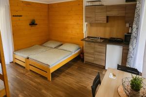 a small room with a bed and a kitchen at Kemp Srdíčko in Doksy +33 photos