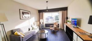 a living room with a white couch and a desk at Type 2 Catho Esa in Angers