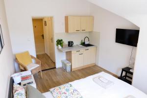 a small room with a bed and a kitchen at Garsonka - Luhačovice in Luhačovice