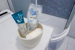 a bathroom with a basket of toothpaste and tooth paste at Garsonka - Luhačovice in Luhačovice +56 photos