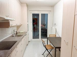a kitchen with a sink and a table and a table at New in Bern 3 bedrooms central and spacious in Bern +10 photos