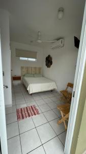 a bedroom with a bed on a tiled floor at San Bernabe Suites in Veracruz