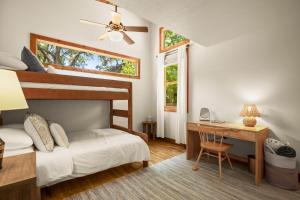 a bedroom with two bunk beds and a desk at Live Oak Hideaway in Austin