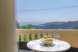 a bowl of bananas on a table on a balcony at Apartment Dragicevic 5 with Garage in Budva
