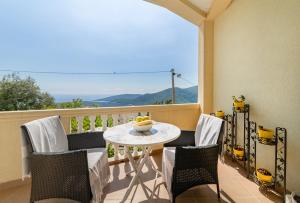 a balcony with a table and chairs with a view at Apartment Dragicevic 5 with Garage in Budva