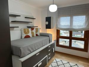 a bedroom with a bed and a window at #Las Azaleas# in Ribadeo