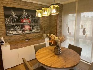 a kitchen with a wooden table with a vase on it at #Las Azaleas# in Ribadeo