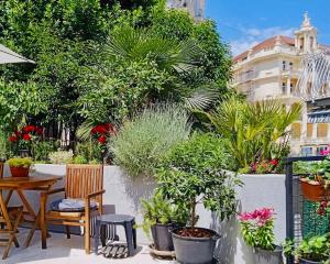 a patio with a table and chairs and plants at Opatija Rooftop Garden Oasis by the Beach ArtSpace in Opatija