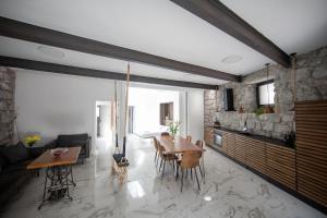 a living room with a table and a couch at Opatija Rooftop Garden Oasis by the Beach ArtSpace in Opatija