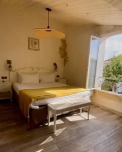 a bedroom with a large bed and a window at Chambre d'hôtes Hôte des Portes Île de Ré in Les Portes