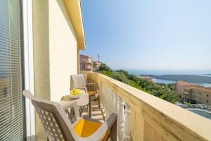 a balcony with chairs and a view of the ocean at Apartment Dragicevic 7 with Garage in Budva