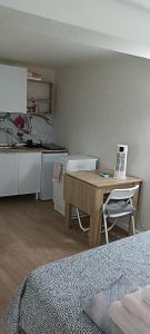 a room with a kitchen and a table with a laptop at Affittacamere Pratello 97 in Bologna