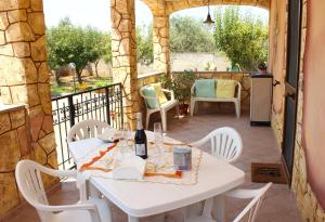 a white table and chairs on a patio at La Rosa dei Venti in Alghero