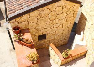 an overhead view of a stone building with plants on a table at La Rosa dei Venti in Alghero