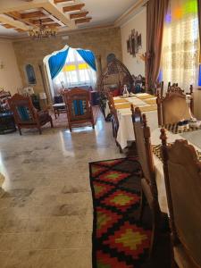 a dining room with tables and chairs and a room with a tent at Maison D'hôte Dar Saida in Sicca Veneria