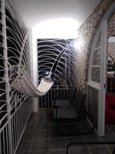 a hammock in the hallway of a house at Ella villa negril in Negril +23 photos