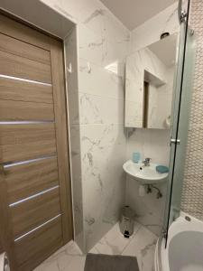 a bathroom with a shower and a toilet and a sink at ''Kristall'' in Ventspils