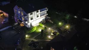 an overhead view of a building at night with lights at TRIIBRIA Guest house in Trigrad