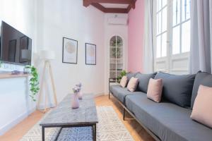a living room with a blue couch and a table at Fliphaus Mansion Paz A 10 pax Deluxe House Belgrano in Buenos Aires