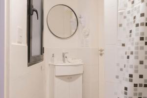 a white bathroom with a sink and a mirror at Fliphaus Mansion Paz A 10 pax Deluxe House Belgrano in Buenos Aires +12 photos