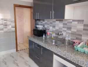a kitchen with a sink and a counter top at Settat, Morocco in Settat