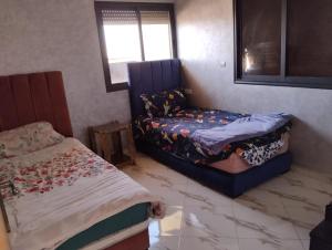 a bedroom with two beds and a window and a bed at Settat, Morocco in Settat