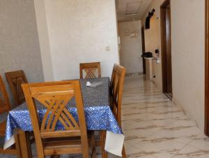 a dining room with a table and chairs at Settat, Morocco in Settat