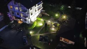 an overhead view of a building at night with lights at TRIIBRIA Guest house in Trigrad