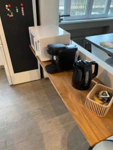 a counter with a coffee maker and a box on it at Hypercentre - Bel appartement cosy 65m Tourcoing in Tourcoing +5 photos