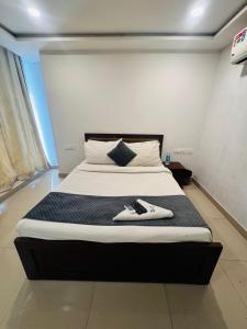 a bed in a room with two shoes on it at Wild Wings Hotel in Hyderabad