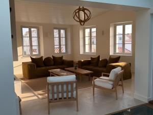 a living room with a couch and a table at Chambre d'hôtes Hôte des Portes Île de Ré in Les Portes
