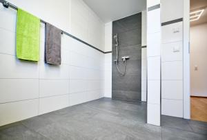 a bathroom with white walls and a shower at Müller s Ferienhäusle UG in Vogtsburg