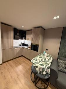 a small kitchen with a table and a bed at Salou Vars Rafayel in Salou +5 photos