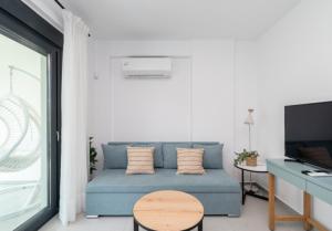 a living room with a blue couch and a table at Diamond D2 Iraklitsa in Iraklitsa