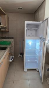 a refrigerator with its door open in a kitchen at Beachfront Ap 314 Kariri Beach in Caucaia