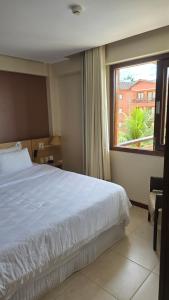 a bedroom with a bed and a large window at Beachfront Ap 314 Kariri Beach in Caucaia +33 photos