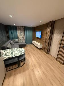 a bedroom with a bed and a couch and a flat screen tv at Salou Vars Rafayel in Salou