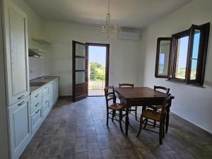 a kitchen with a table and chairs and a dining room at Borgo Amarrante in Montaione