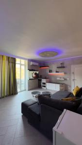 a living room with a black couch and a purple ceiling at House Shengjin in Shëngjin