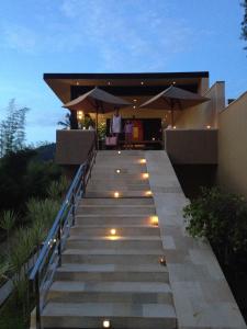 a set of stairs leading to a house with lights at The Puncak Lombok in Senggigi