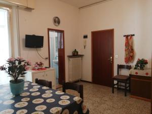 a living room with a table and a room with a tv at Home 132 in Gatteo a Mare