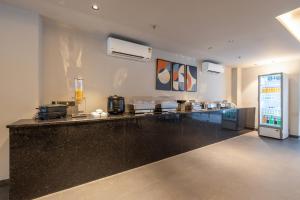 a kitchen with a black counter top in a room at One Stayz, sector 70A, Gurugram near Sohna Road in Gurgaon