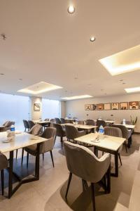 a restaurant with tables and chairs in a room at One Stayz, sector 70A, Gurugram near Sohna Road in Gurgaon