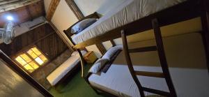 an overhead view of two bunk beds in a room at Hostal ElRojo Montañita in Montañita