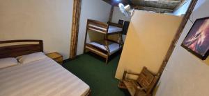 a bedroom with a bed and a chair in it at Hostal ElRojo Montañita in Montañita