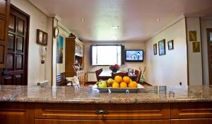 a kitchen with a bowl of fruit on a counter at VILLA PAQUITA Anero in Anero +20 photos