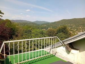 a balcony with a view of the mountains at Chambres d'hôtes du Domaine de Cabrières in Saint-Jean-du-Gard +4 photos