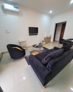 a living room with a couch and a tv at Appartement Amani in Kinshasa