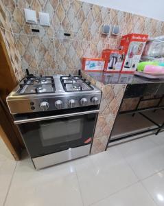 a kitchen with a stove and a counter at Appartement Amani in Kinshasa