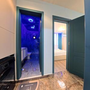 a room with a bathroom with a blue wall at Premium apartment in Ureki +51 photos